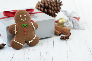 Traditional christmas gingerbread cookies over a wooden table with gift box