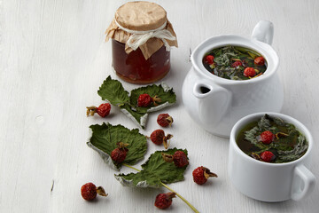 Herbal tea with rose hips, currant leaves and a jar of jam