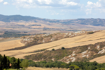 Obraz premium Val d' Orcia (SI), Italy - August 05, 2021: Typical landscape in val d' Orcia, Tuscany, Italy