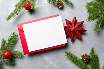 Fototapeta na wymiar Christmas greeting or invitation card mockup with red envelope and festive decorations