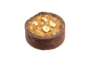 Mini caramel tart with hazelnuts isolated on white