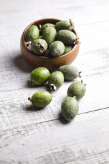 Feijoa fruits or pineapple guava in bowl on wooden table
