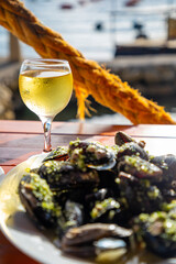 Dish with mussels and wine on the seashore in Montenegro