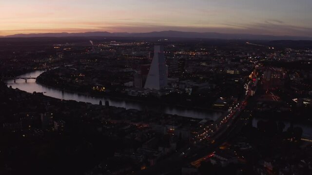 Aerial shows basel city from right to left with the Rhine after Sunset, Switzerland