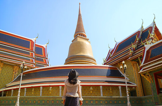 Female Visitor Impressed by a 43 Meters High Gilded Pagoda and the Circular Gallery of Wat Ratchabophit Buddhist Temple, Bangkok, Thailand