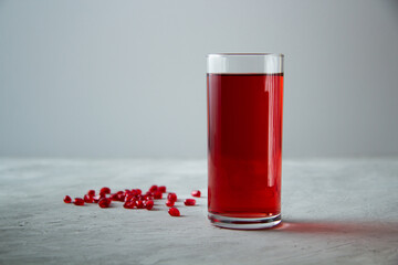 pomegranate juice with pomegranate seeds on a light background. Vitamin and mineral co. Pomegranate juice contains biologically active substances. 