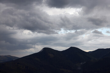 Obraz na płótnie Canvas View of sky with grey thunder clouds over mountains