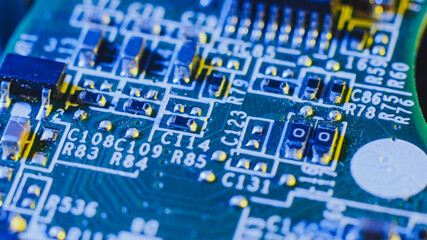 Old electronic circuit board close up in macro photography, blue lighting