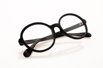 Eyeglasses And Its Reflection Against Light Background