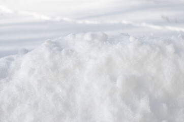 Fototapeta na wymiar Pure white snow on a clear sunny day. Horizontal photo of snow texture