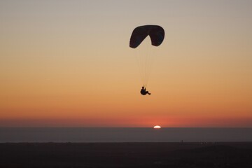 paraglider silhouette at sunset