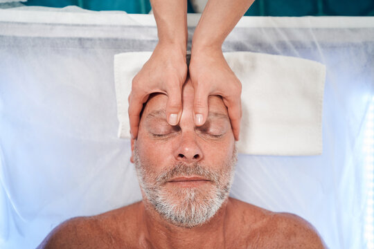 Man Receiving Professional Scalp Massage In Spa Salon