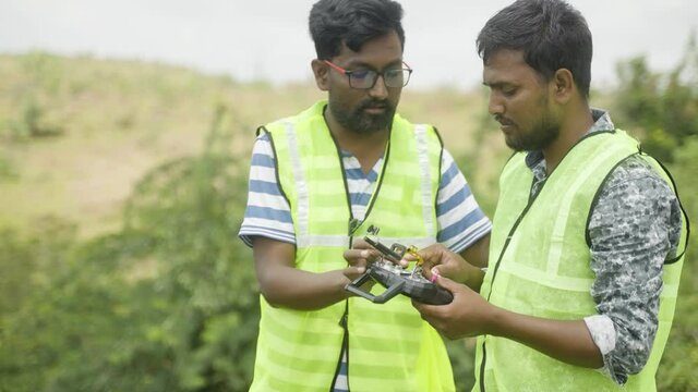 Trainer teaching by explaining about drone remote controller operations to student - Concept real life practical drone or UAV pilot training