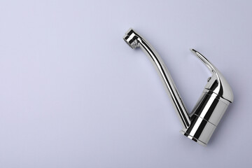 Single handle water tap on grey background, top view. Space for text