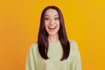 Fototapeta premium Photo of young excited girl amazed surprised omg wow news sale isolated over yellow color background