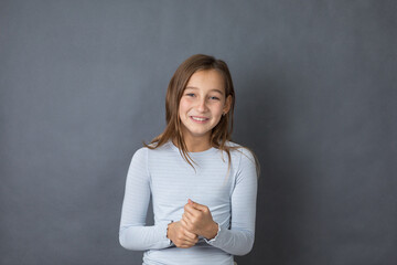 Portrait of a young happy girl on grey background with space for text - 463842798