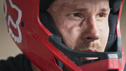 Portrait of young adult mountainbiker wearing full face helmet
