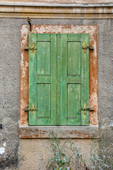 Fototapeta na wymiar Old window with closed shutters