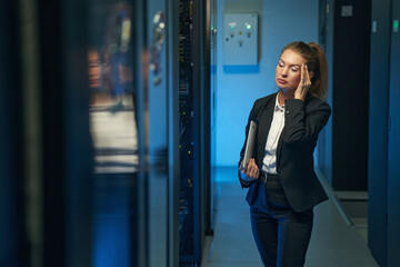 Woman standing in hallway of data center