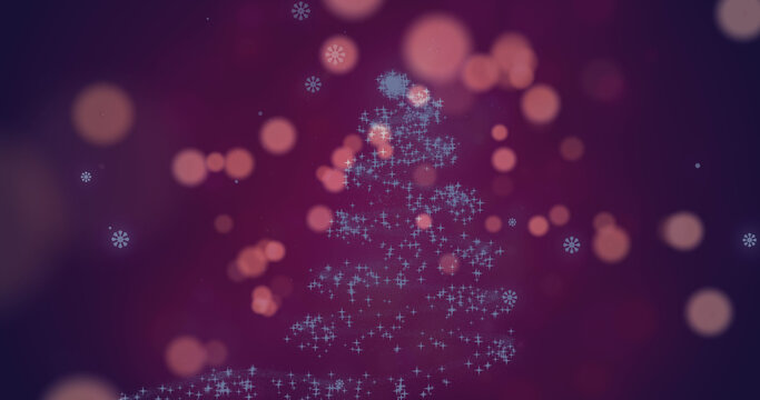 Image of spots of lights falling over glowing christmas tree