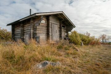 Traditional wooden cabin in Finnish Lapland. One of the huts in Pallas-Yllastunturi national park, Finland. Autumn day in remote arctic landscape.