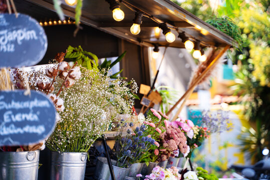 Street market stall full of pots with glowers and plants