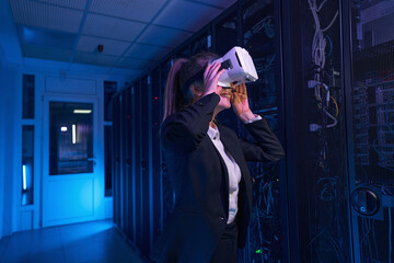 Cheerful woman wearing virtual reality headset indoors