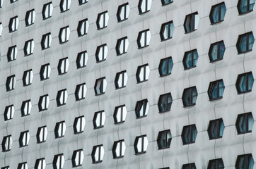 the facade of the building with many windows in the form of honeycombs.