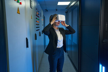 Young female use virtual reality device in data center