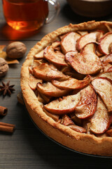 Delicious apple pie on wooden table, closeup