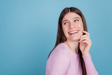 Fototapeta premium Profile side photo of cheerful girl happy positive toothy smile curious look empty space isolated over blue color background