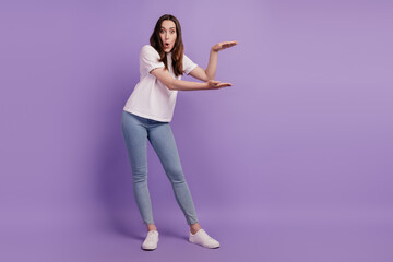 Full size photo of young girl showing hands measure little small size amazed surprised isolated...