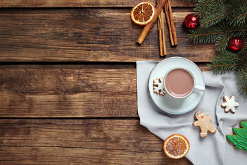 Flat lay composition with delicious hot chocolate and Christmas decor on wooden table, space for text