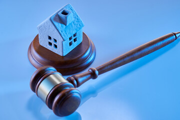 Obraz premium Gavel wooden and house for home buying or selling of bidding or lawyer of home real estate and building concept.