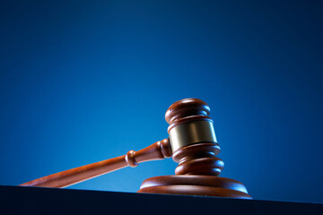 A wooden judge gavel and soundboard