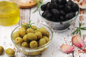 Black and green olives in glass bowls	