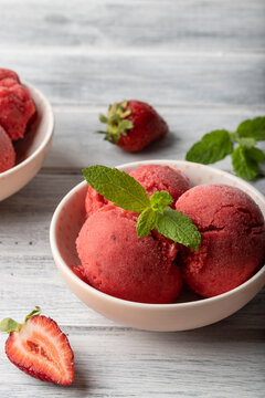 Homemade strawberry banana nice cream, fresh mint and strawberries
