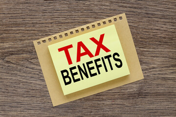 TAX BENEFITS. yellow office stickers. business concept