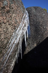 Icicles hang from the stone wall.