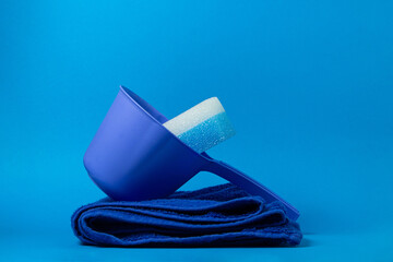 Bath accessories on a blue background. Blue bathing sponge