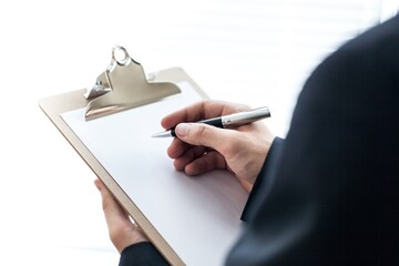 Person Taking Notes on a Clipboard