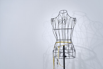 Stylish wire tailor's mannequin isolated on white