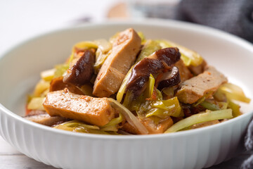 Homemade stir-fried dried beancurd with leek sprouts.