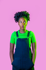 Young black woman posing looking up curious and interested thinking new idea isolated background