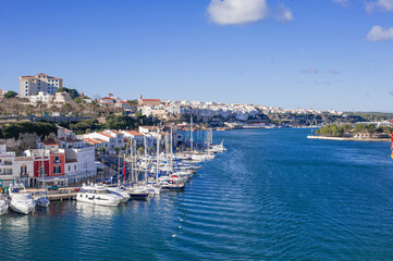 Fototapeta na wymiar large luxury sailing yachts with folded sails moored in Mahon Bay on a sunny day