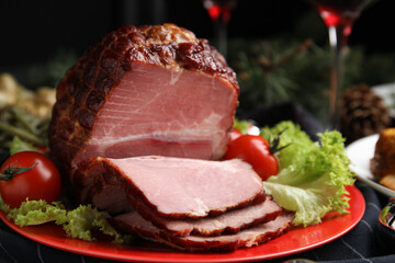 Plate with delicious ham, lettuce and tomatoes on black wooden table, closeup