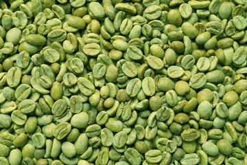 Many green coffee beans as background, top view