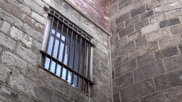 Barred window in a wall at Eastern State Penitentiary.