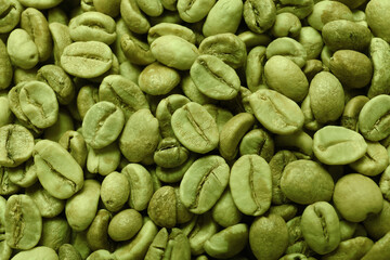 Many green coffee beans as background, top view