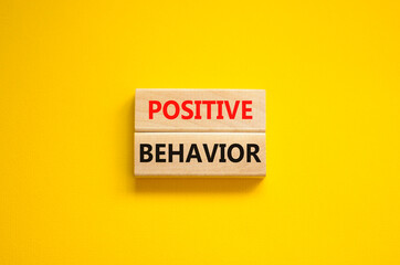 Positive behavior support symbol. Concept words Positive behavior on wooden blocks on a beautiful yellow background. Business, psychological and Positive behavior support concept. Copy space.